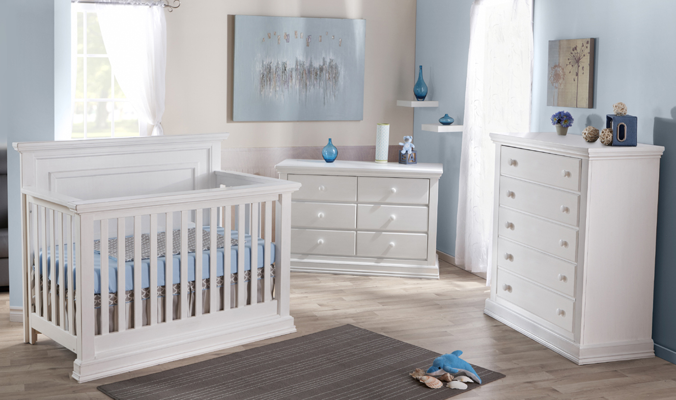 The gorgeous <b>Modena Forever Crib</b> with a <b>2106 Double Dresser</b> and a <b>2105 5 Drawer Dresser</b>, in Vintage White.