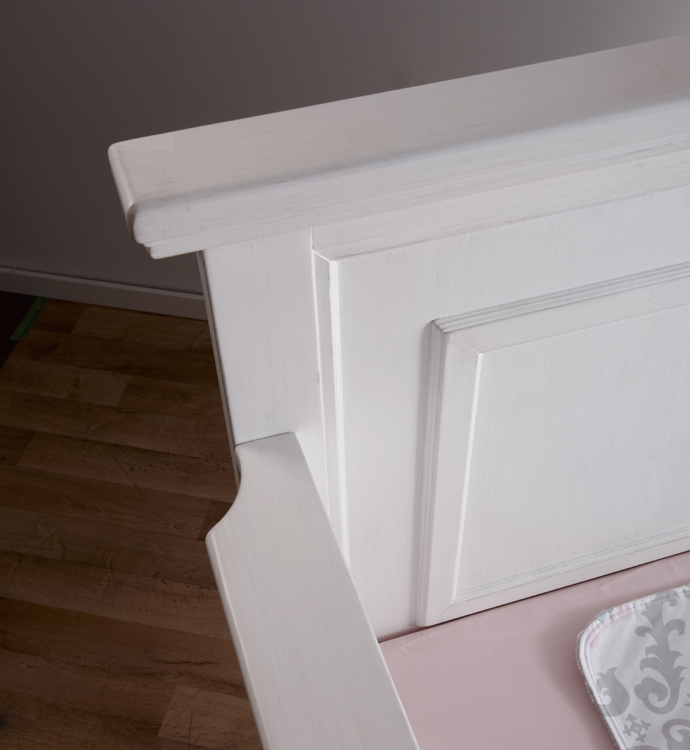 A detail of the gorgeous <b>Modena Forever Crib</b>, in Vintage White.